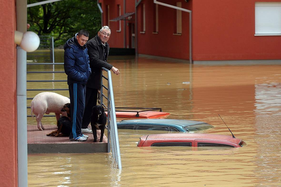 People wait to be evacuated from their flooded home in the town of Obrenovac, Serbia