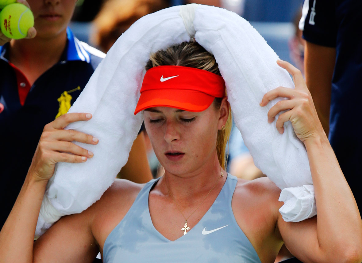 Maria Sharapova of Russia uses an ice pack to cool off during a break in her match against Caroline Wozniacki of Denmark at the 2014 US Open tennis tournament in New York