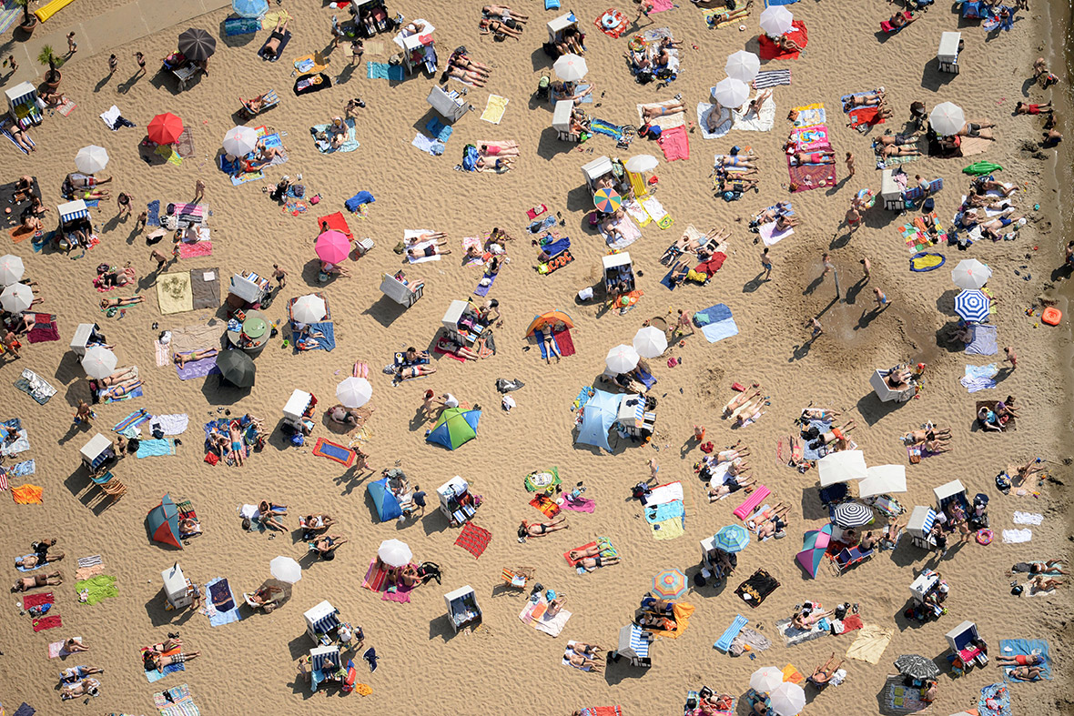 An aerial view shows people on the beach of the Wannsee lake in Berlin, Germany