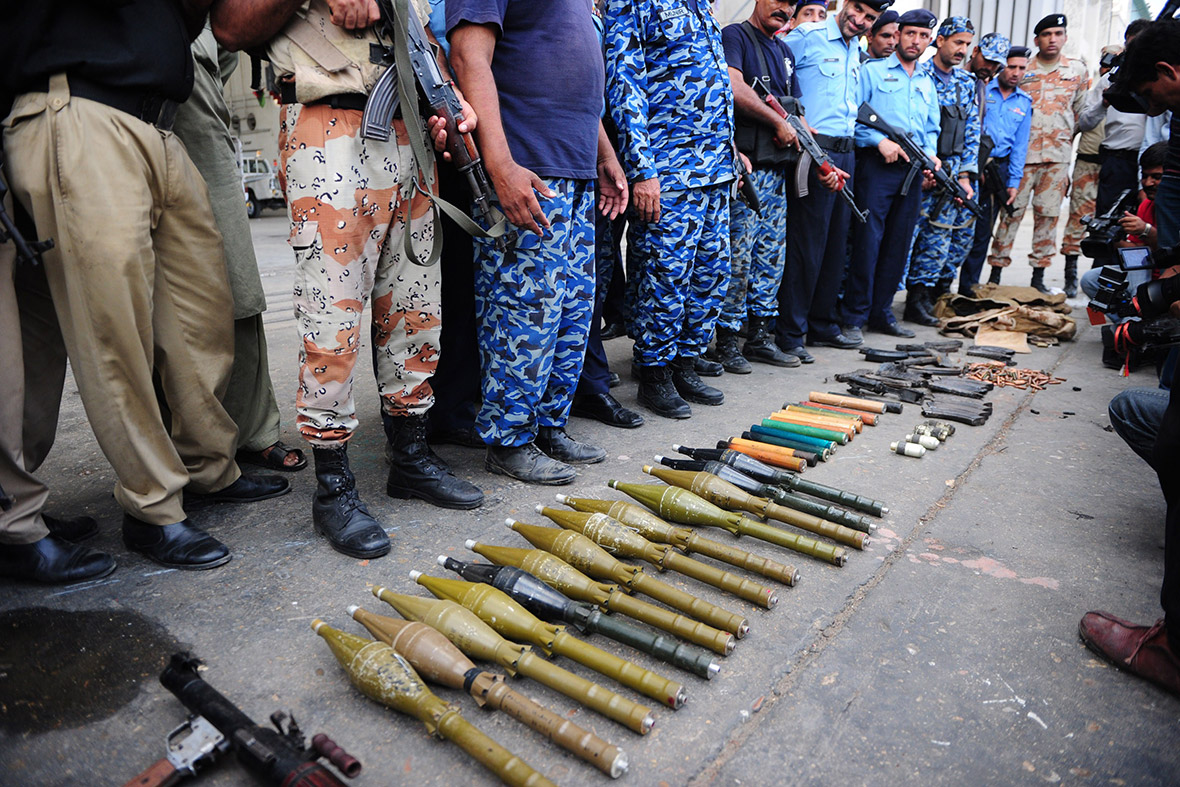Pakistani policemen display seized weapons after militants attacked Jinnah International Airport in Karachi