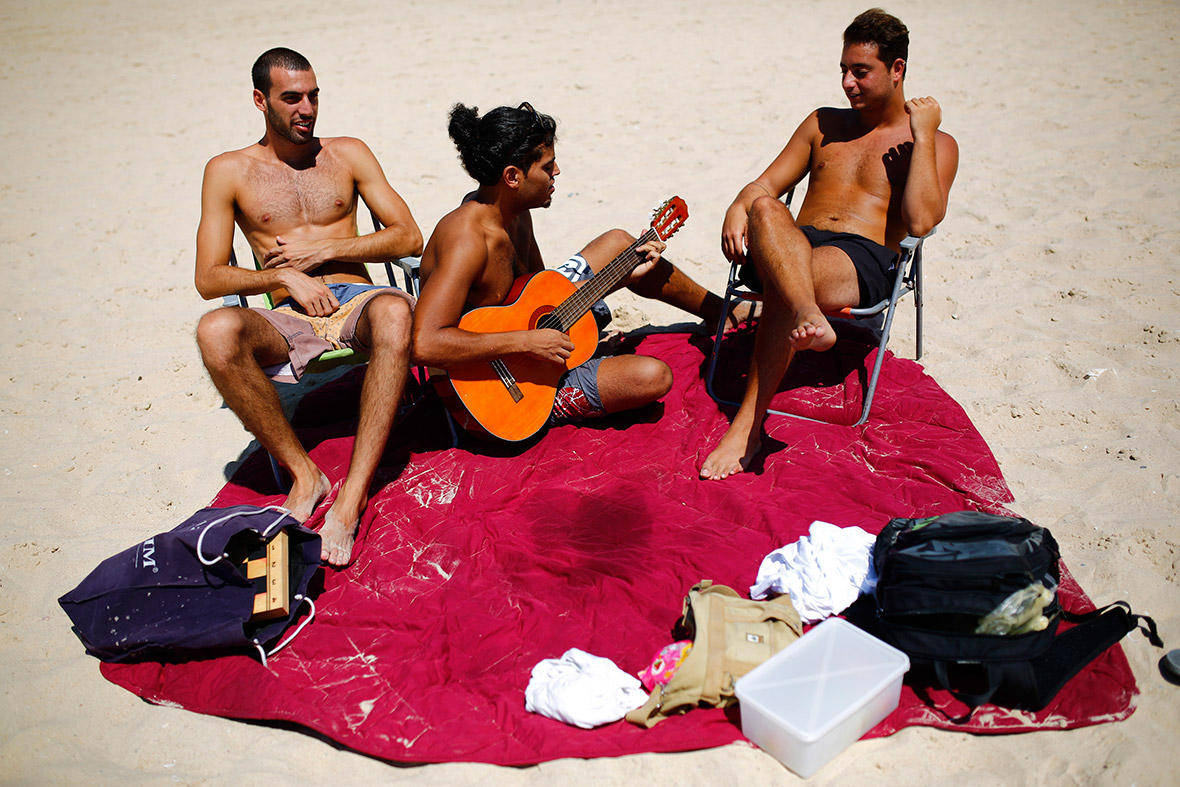 Israelis relax on the shore of the Mediterranean sea in the southern Israeli city of Ashkelon as a 72-hour truce appeared to be holding