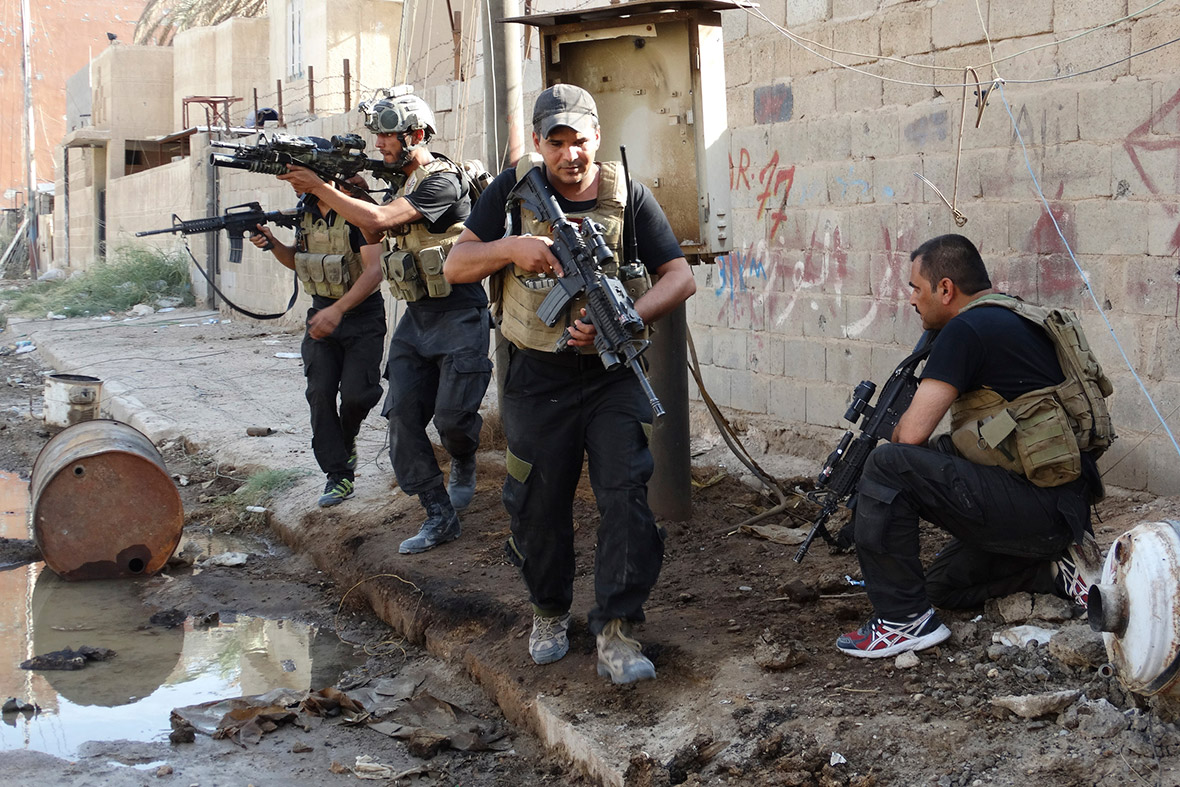Members of the Iraqi Special Operations Forces take up positions during clashes with Isis militants