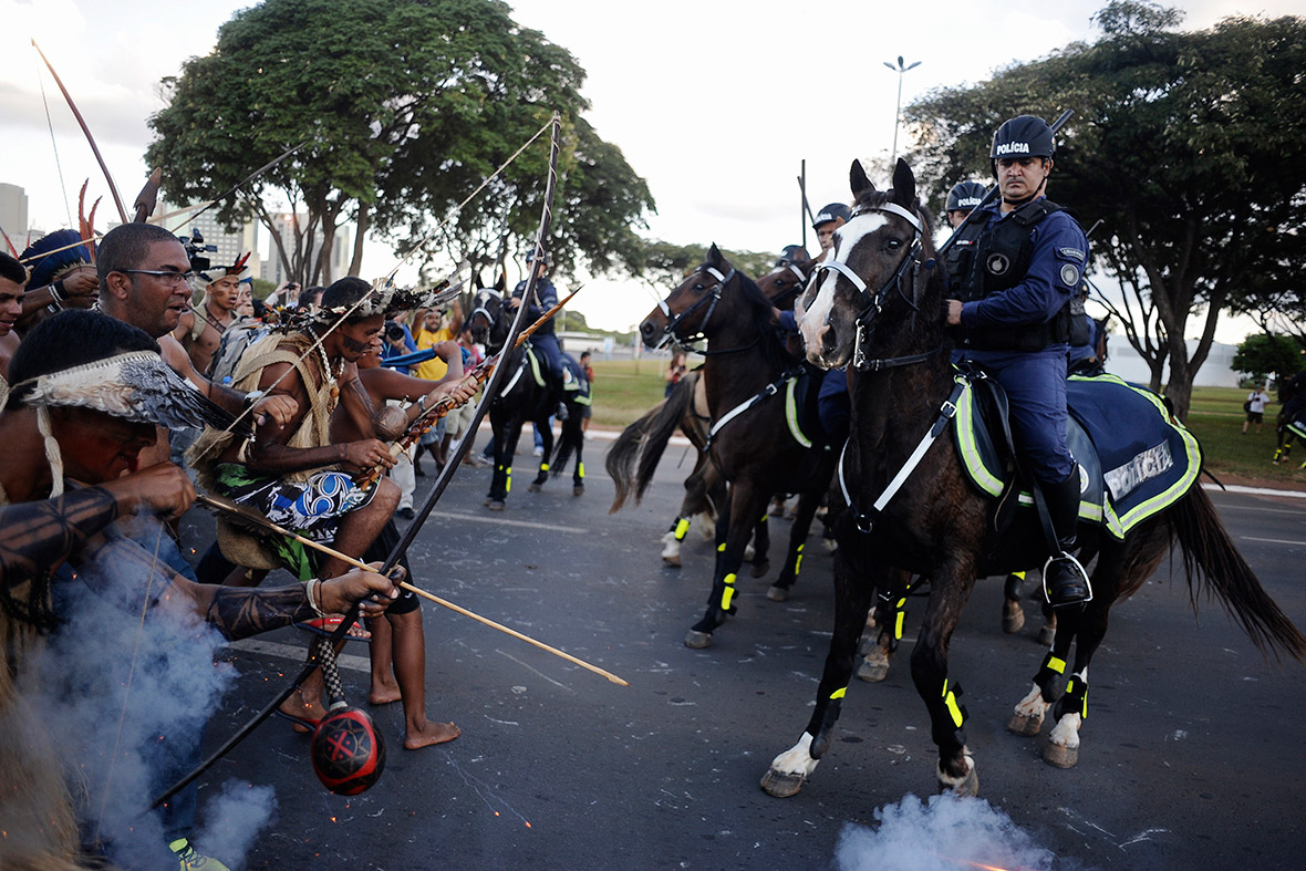 Police use tear gas to impede indigenous Brazilians from marching towards the Mane Garrincha stadium in Brasilia