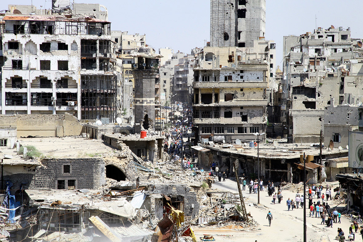 Residents return to the bombed-out city of Homs to inspect their homes, after the cessation of fighting between rebels and forces loyal to Syria's President Bashar al-Assad