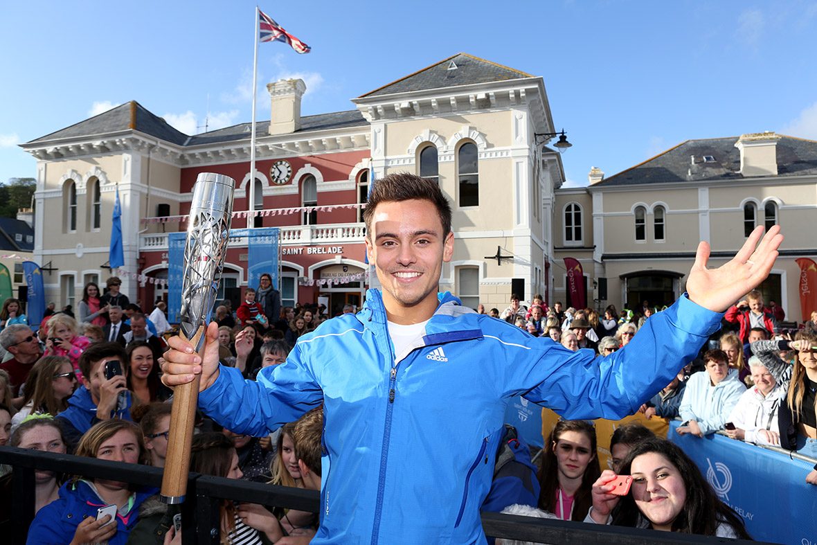 Tom Daley brings the Commonwealth Games Baton back to British soil at St Aubins Harbour, Jersey