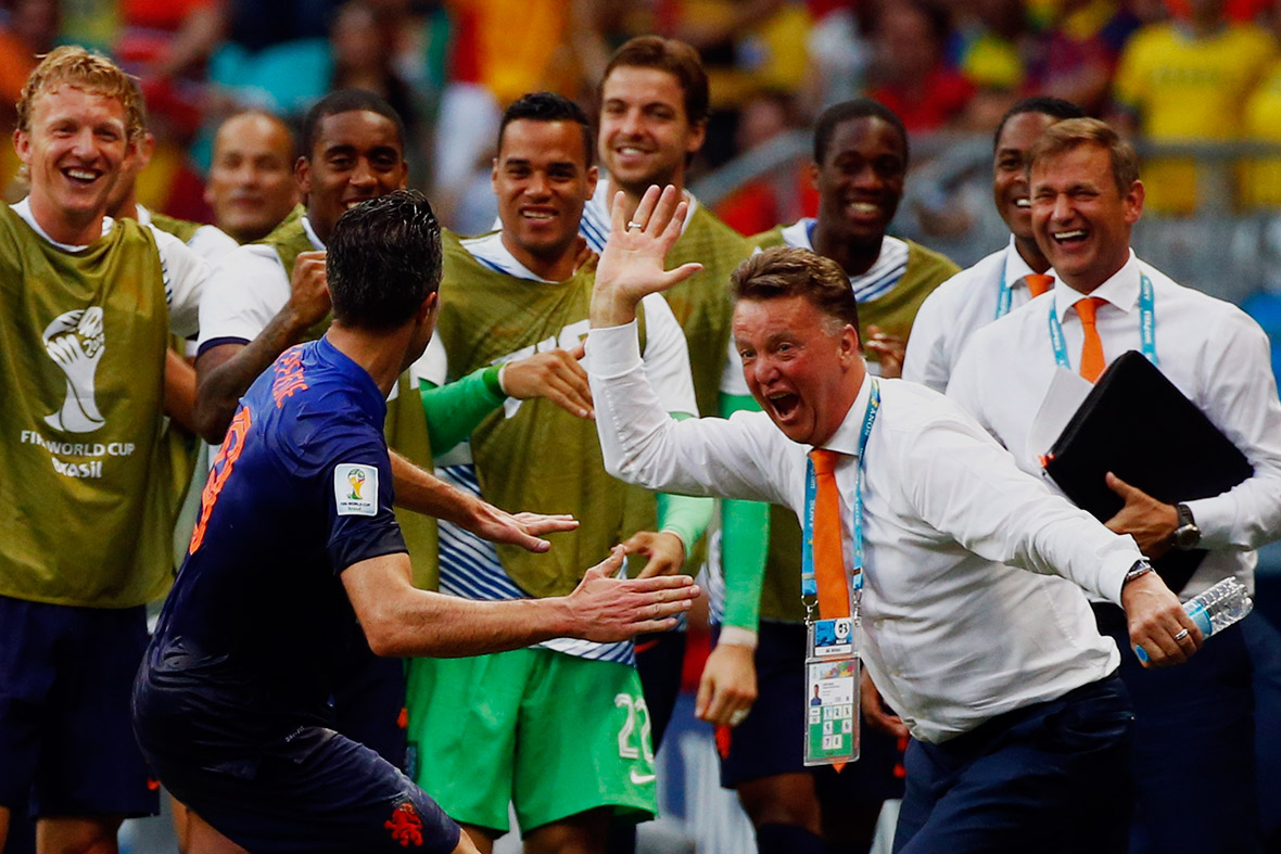 Robin van Persie of the Netherlands celebrates his goal against Spain with coach Louis van Gaal during their 2014 World Cup Group B match in Salvador on June 13, 2014