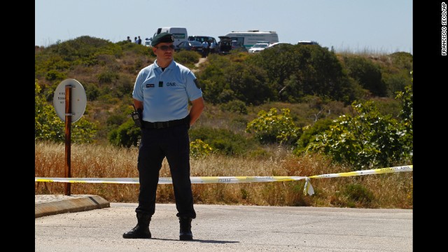 A Portuguese Republican Guard policeman stands guard as police begin digging in an area of wasteland near Praia da Luz on Monday, June 2.