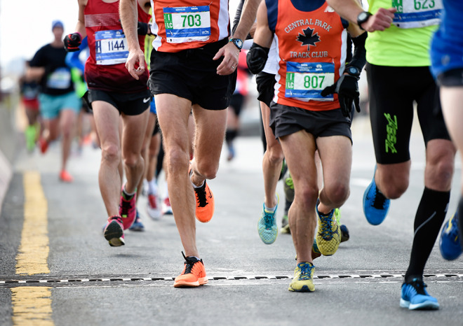 A sea of feet pound the pavement as runners cross the Pulaski Bridge to enter the Queens borough of New York during the New York City Marathon on Sunday, Nov. 2, 2014, in New York.