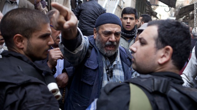 A Palestinian man argues with Israeli police officers as he waits to get permission to enter the Temple Mount on Wednesday, November 5, in Jerusalem. Police clashed with Palestinians there on Wednesday, leaving more than 15 people injured in the latest round of unrest at the holy site.