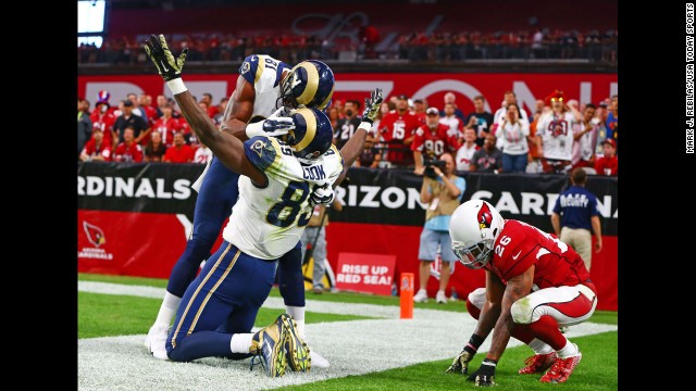 St. Louis Rams tight end Jared Cook celebrates his touchdown catch with wide receiver Kenny Britt as Arizona Cardinals safety Rashad Johnson reacts in the second quarter at the University of Phoenix Stadium in Glendale, Arizona, on Sunday, November 9. Arizona won 31-14.