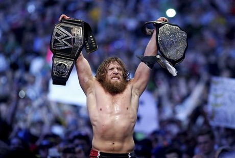 This April 6, 2014 photo provided by the WWE shows Daniel Bryan celebrating after winning the main event during Wrestlemania XXX at the Mercedes-Benz Super Dome in New Orleans. Police say the former WWE champion, Bryan chased two burglary suspects he saw exiting his Phoenix home this week and subdued one until officers arrived. 