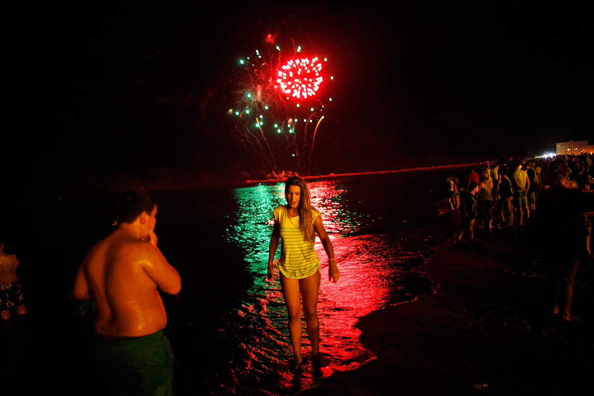 People watch a San Juan fireworks display at La Misericordia beach in Malaga, Spain. On the night of San Juan, people burn objects they no longer want and make wishes as they jump through flames or swim in the sea