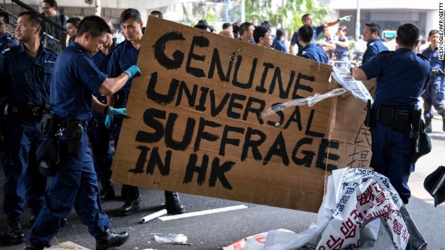 Hong Kong police remove a sign as they dismantle barricades built by pro-democracy protesters on October 14, 2014. Demonstrators are angry about China's decision to allow only Beijing-vetted candidates to run in the city's elections for chief executive in 2017.