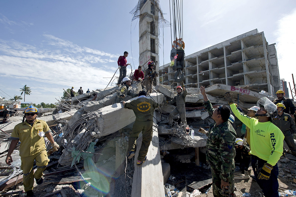 Rescue workers search for any people trapped under a six-storey building under construction that collapsed, in Pathum Thani province, Thailand