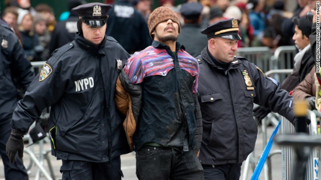 A protester is arrested in New York during the Macy's Thanksgiving Day Parade on Thursday, November 27.