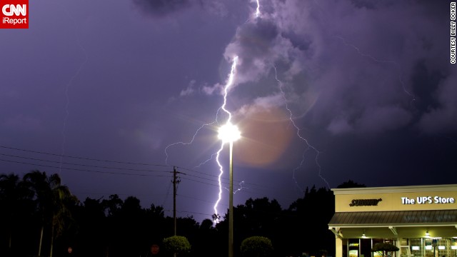 It's only an optical illusion, but lightning appears to be striking a lamppost in this June photo from <a href='http://ift.tt/1oNlAq0'>Billy Ocker</a>. "The storm was wicked strong," he remembered.