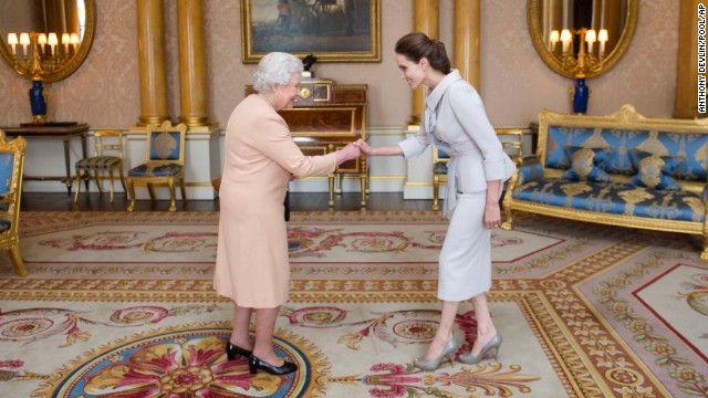 On Friday, October 10, Britain's Queen Elizabeth II made Angelina Jolie an honorary dame for her work to root out sexual violence in war zones. While Jolie is now known for her humanitarian works and action movies, she has been in the spotlight since she was a child. Here's a look at her life.