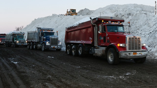 Dump trucks wait to unload snow that was removed from south Buffalo, New York, neighborhoods on November 21. 