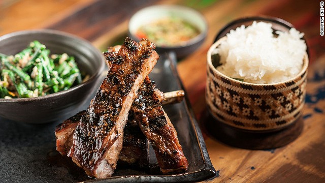 New York City restaurant Khe-Yo serves Laotian-inspired Southeast Asian cuisine. On the dinner menu: Berkshire spare ribs (ping sien moo) with sticky rice and a long bean and cherry tomato salad. 