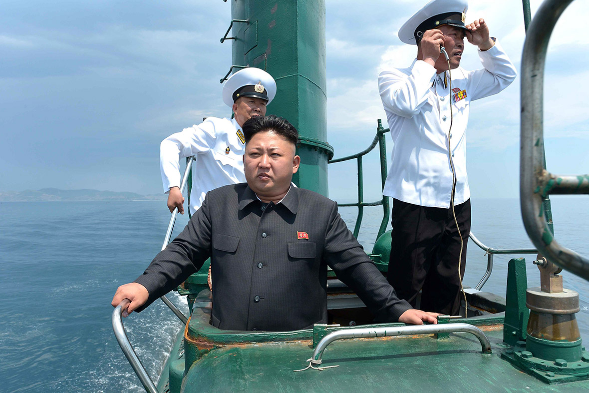 North Korean leader Kim Jong-un stands in a hatch on the conning tower of a submarine during his inspection of the Korean People's Army Naval Unit 167