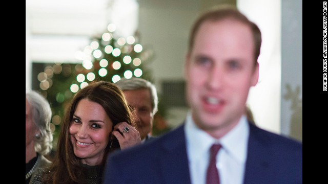The duchess smiles while she listens to Prince William talk to guests December 8 at a reception in New York co-hosted by the Royal Foundation and the Clinton Foundation.