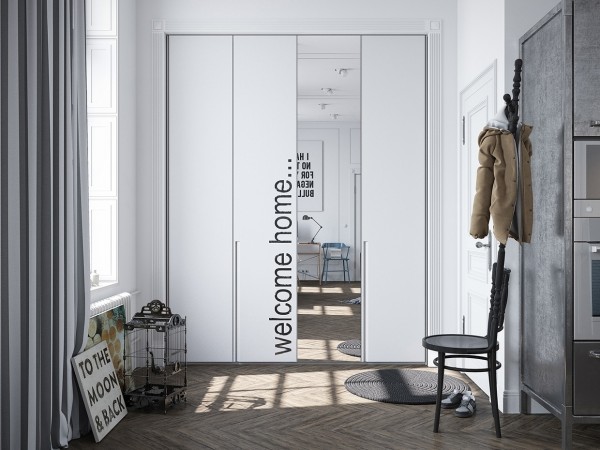 An artistic mirror sits at the entrance to the apartment with a lovely typographical accent.
