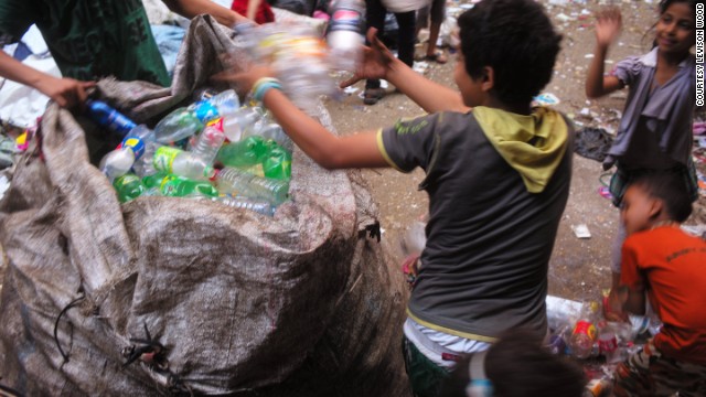 Coptic Christians in Cairo's El Zabaleen (garbage city) slum sift through piles of trash.