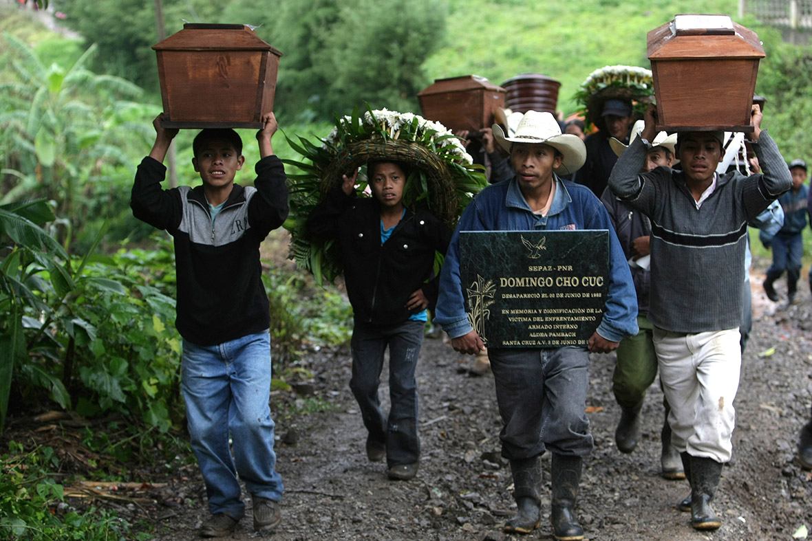 People carry tombstones and coffins after the remains of six people who had disappeared on 2 June 1982 during the Guatemalan Civil War are returned to the community, at Pambach in the Alta Verapaz region. The skeletons were found during an archaeological investigation at the regional command headquarters of the Guatemalan Army