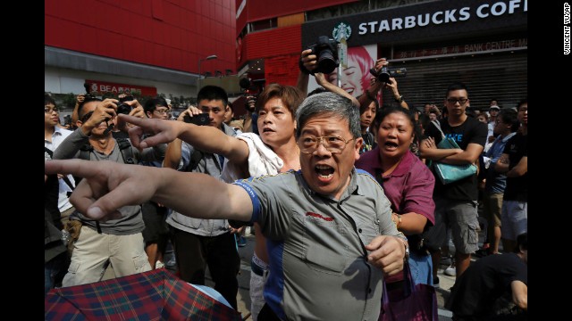 People shout at pro-democracy protesters in Hong Kong's Mong Kok district on Friday, October 17. 
