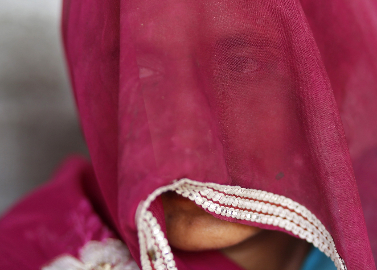 The veiled mother of one of the two teenage girls who were raped and hung in Budaun district of Uttar Pradesh, sits inside her house. The two cousins, from a low-caste community, aged 14 and 15, went missing from their village home after going out to the toilet. The next morning, villagers found their bodies hanging from a mango tree in a nearby orchard.