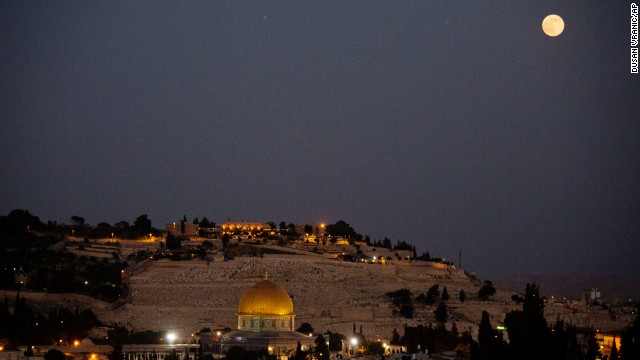 The moon over Jerusalem's Old City and the Dome of the Rock.