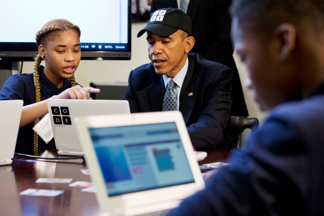 Adrianna Mitchell, a middle-school student from Newark, NJ, explains a coding learning program to President Barack Obama during an “Hour of Code” event in the Eisenhower Executive Office Building on the White House complex in Washington, DC, on Monday, Dec. 8, 2014.