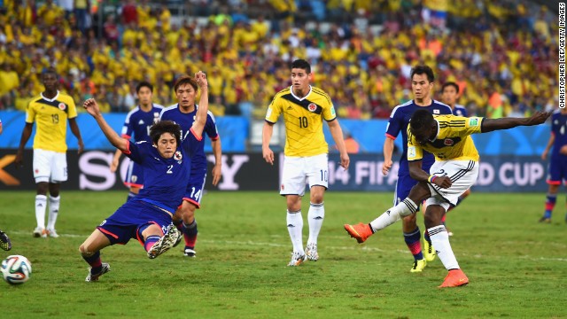 Jackson Martinez of Colombia shoots and scores his team's second goal against Japan.