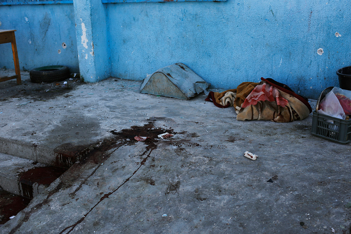 Blood runs down the stairs at the United Nations-run school in Beit Hanoun