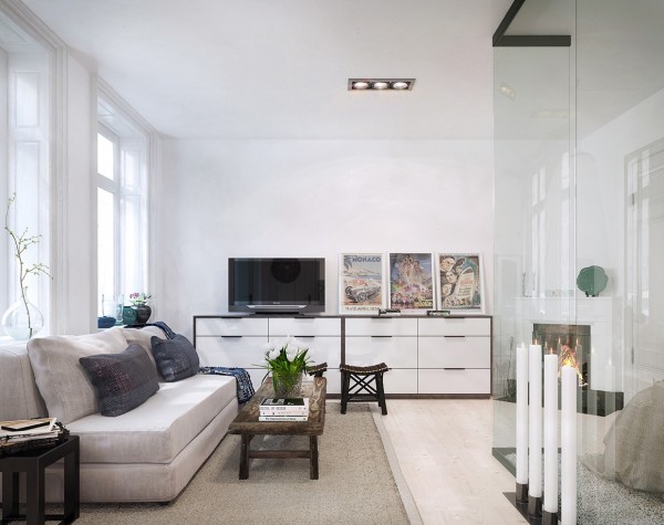 This Stockholm apartment uses lots of white and natural materials, as is quite common in Swedish design. The interior glass wall creates a partition between the bedroom and living area, but again does not provide much in the way of privacy.
