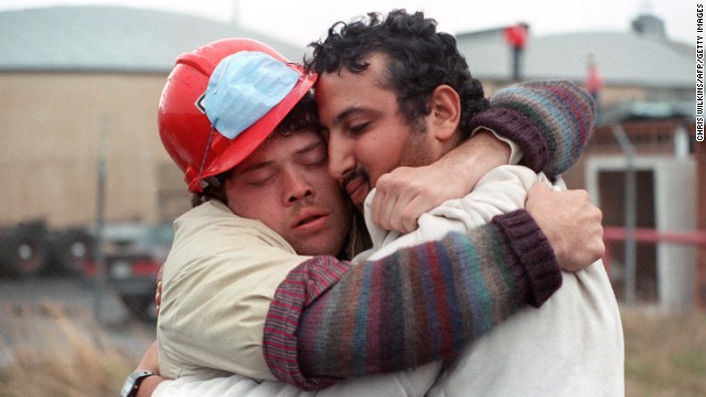 Search-and-rescue workers Tim Schilwachder, left, and Mamdouch Shabaan embrace shortly after a man was rescued from the Cypress Street Viaduct, a raised freeway in Oakland, California, that collapsed during the earthquake.