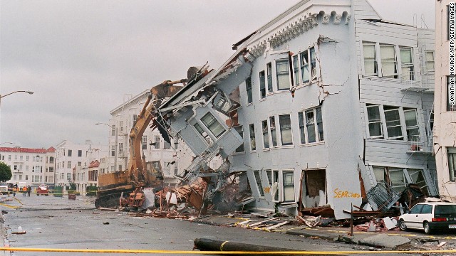 A destroyed apartment building is demolished in the Marina District.