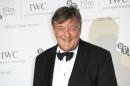 In this Tuesday, Oct. 7, 2014, file photo Stephen Fry poses for photographers upon arrival at the British Film Institute London Film Festival Gala Dinner in central London. Actor-comedian Stephen Fry says he is getting married _ and is "very, very happy" even though his hopes of a private wedding have been dashed. Fry, who is 57, and 27-year-old partner Elliott Spencer gave formal notice of their plans to wed at the register office in Dereham, eastern England. Fry’s office says no date has been set. (Photo by John Phillips Invision/AP Images)