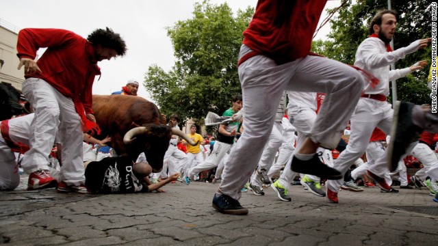 A bull jumps over revelers near the end of the run on July 9.