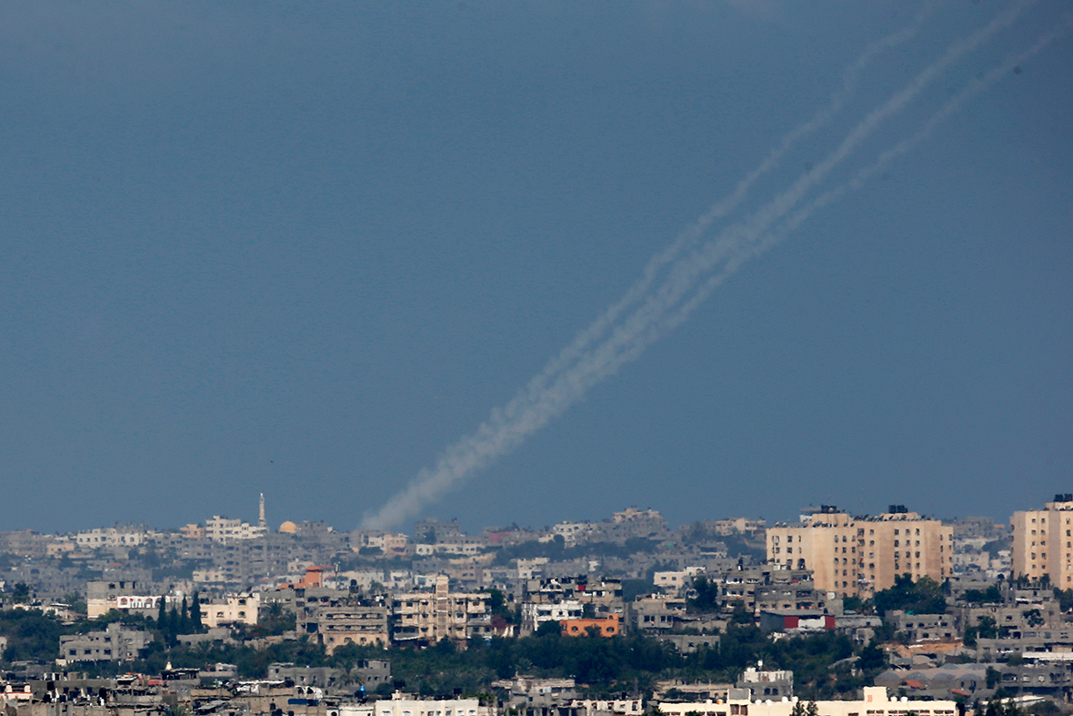 Smoke trails are seen as rockets are launched towards Israel from northern Gaza