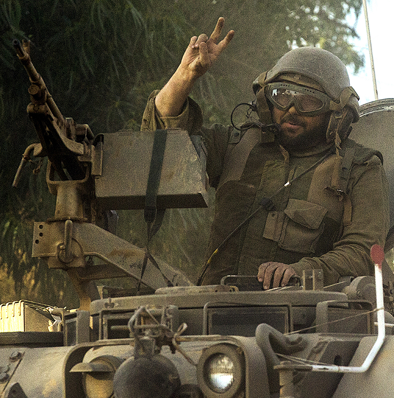 An Israeli soldier flashes the V-sign for 