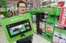 A customer holds a box containing Microsoft's video game console "Xbox One" at a household appliance shop in Tokyo
