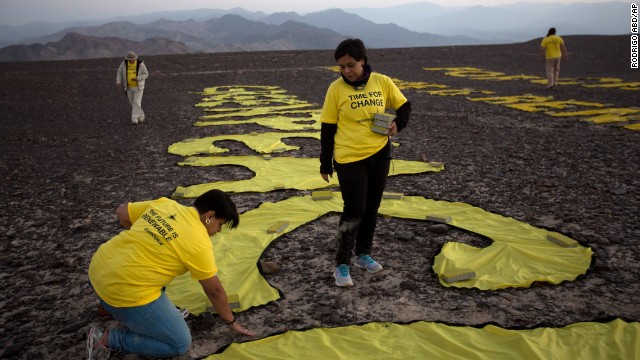 Greenpeace activists, who arranged the letters of their message next to a famous hummingbird geoglyph, timed their December 8 demonstration to a United Nations conference on climate change in Lima.