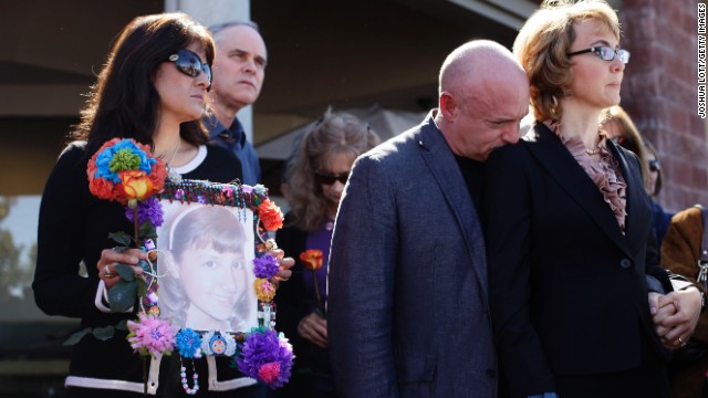 Giffords and Kelly attend a news conference on March 6, 2013 outside the Safeway grocery store in Tuscon. At the event they urged Congress to provide stricter gun control in the United States. At left, Roxanna Green holds a photo of her daughter, Christina Taylor Green, who was killed in the 2011 shooting.