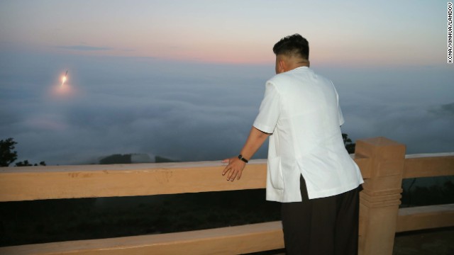 Kim watches a tactical rocket firing drill in June.