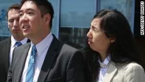 Matthew and Grace Huang speak to reporters outside the entrance of the Court of First Instance before their trial in Doha, March 27, 2014.