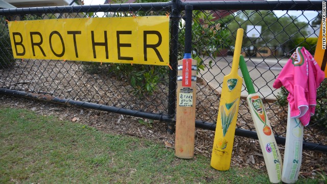 Cricket bats and signs are placed outside St. Patrick's Primary School hours before the funeral of Australian batsman Phil Hughes. 