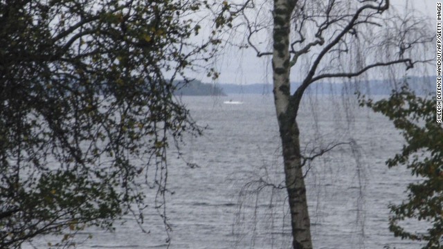 In this handout from the Swedish Defense Ministry, a dark object in a white wake is seen in the Baltic Sea. Some suspect it is the mysterious vessel the Swedish Navy is looking for.