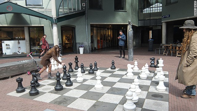The Chess Museum is located inside a former prison. Outside, punishments are still doled out on the giant game board overlooked by a bust of Max Euwe.