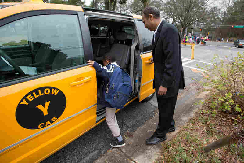 Most days, Shekhey uses his taxi to help transport refugees who have no other transportation and to shuttle children to an after-school program he runs at a local church. Here, he picks up Milkeso Sayida, 8, from Indian Creek Elementary School.
